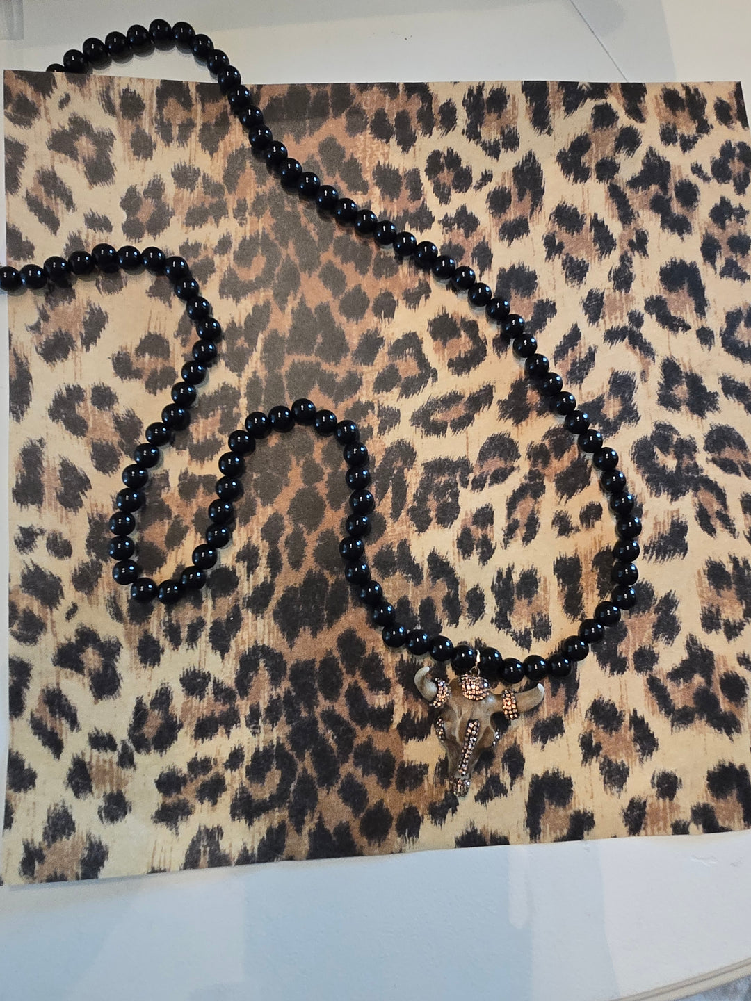 Long Black beaded necklace with gold charm